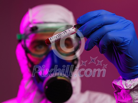 Coronavirus, Doctor holding positive covid-19 virus Blood Sample tube. Wearing biohazard epidemic Protective mask, suit and glows. Coronavirus, Doctor holding positive covid-19 virus Blood Sample tube. Wearing biohazard epidemic Protective mask, suit and glows.