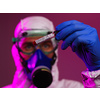 Coronavirus, Doctor holding positive covid-19 virus Blood Sample tube. Wearing biohazard epidemic Protective mask, suit and glows.