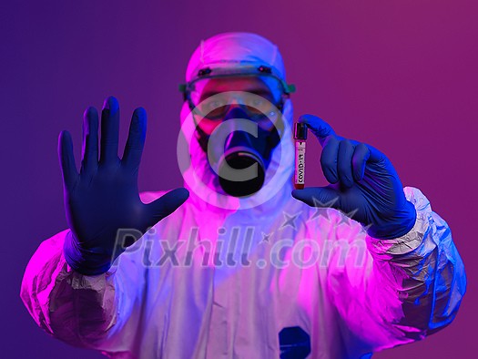 Coronavirus, Doctor holding positive covid-19 virus Blood Sample tube. Wearing biohazard epidemic Protective mask, suit and glows. Coronavirus, Doctor holding positive covid-19 virus Blood Sample tube. Wearing biohazard epidemic Protective mask, suit and glows.