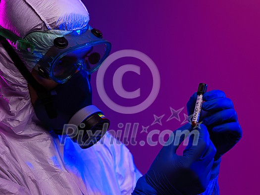 Coronavirus, Doctor holding positive covid-19 virus Blood Sample tube. Wearing biohazard epidemic Protective mask, suit and glows. Coronavirus, Doctor holding positive covid-19 virus Blood Sample tube. Wearing biohazard epidemic Protective mask, suit and glows.