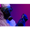 Coronavirus, Doctor holding positive covid-19 virus Blood Sample tube. Wearing biohazard epidemic Protective mask, suit and glows.