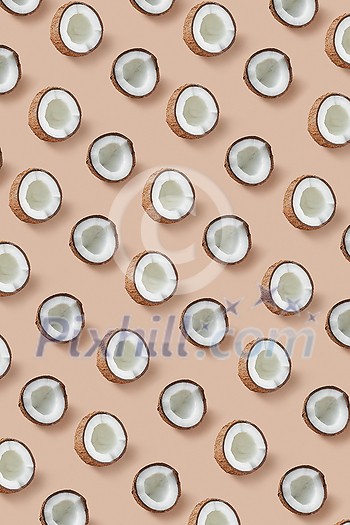 Decorative fruits pattern from natural organic exotic coconut's halves on a beige background. Flat lay. Vegan concept. Decorative fruits pattern from natural organic exotic coconut's halves on a beige background. Flat lay. Vegan concept.