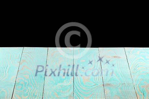 Natural light blue wooden textured empty backdrop on a black background, copy space. Blank wooden table. Can be used for your creativity.