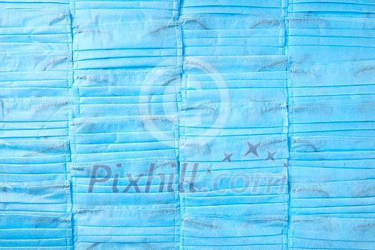 Creative medical backdrop from medical antibacterial protective blue face masks. Concept of prevention from respiratory sickness and viruses. Creative medical backdrop from medical antibacterial protective blue face masks. Concept of prevention from respiratory sickness and viruses.
