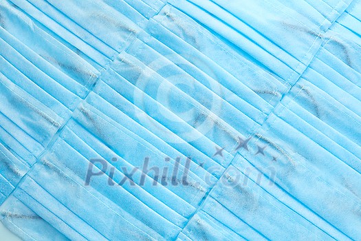 Medical creative background from antibacterial protective blue face masks diagonally arranged. Concept of prevention from respiratory sickness and viruses. Medical creative background from antibacterial protective blue face masks diagonally arranged. Concept of prevention from respiratory sickness and viruses.