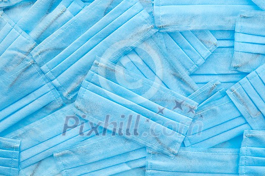 Medical creative backdrop from antibacterial protective blue face masks chaotically arranged. Concept of prevention from respiratory sickness and viruses. Medical creative backdrop from antibacterial protective blue face masks chaotically arranged. Concept of prevention from respiratory sickness and viruses.