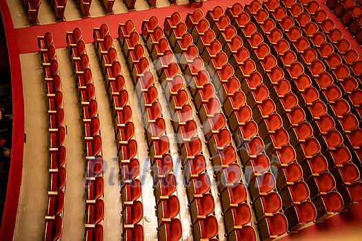 View of the empty parterre in the theatre concert hall of Vienna State Opera auditorium with red seats in the rows without people in Vienna, Austria. View of the empty parterre in the theatre concert hall of Vienna State Opera auditorium with red seats in the rows without people in Vienna, Austria.