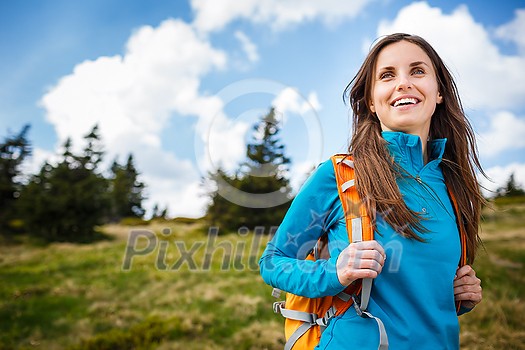 Pretty, young woman hiking outdoors in splendid alpine setting Pretty, young woman hiking outdoors in splendid alpine setting