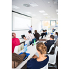 People in a conference room listening to a speech