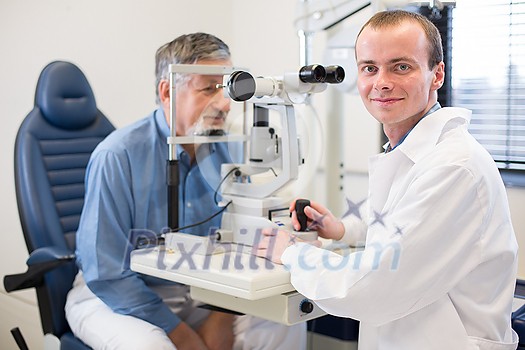 Optometry concept - pretty young woman having her eyes examined by an eye doctor Optometry concept - pretty young woman having her eyes examined by an eye doctor