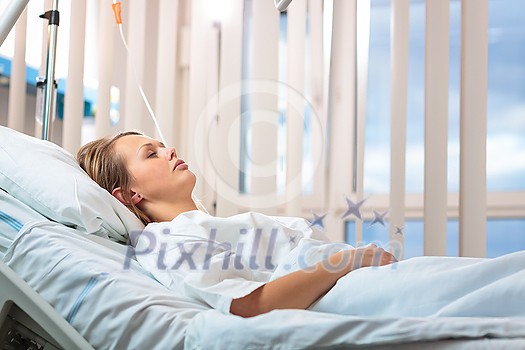 Pretty, young, female patient in a modern hospital room. Getting better fast after a surgery - pensive yet positive, thinking ahead, making plans (shallow DOF; color toned image) Pretty, young, female patient in a modern hospital room. Getting better fast after a surgery - pensive yet positive, thinking ahead, making plans (shallow DOF; color toned image)