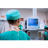 Female anesthesiologist with vital functions monitor in surgery room (color toned image; shallow DOF)