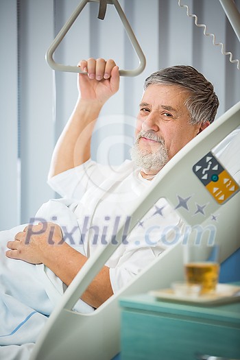 Senior male patient in a modern hospital. Getting better after a surgery/illness (shallow DOF; color toned image) Senior male patient in a modern hospital. Getting better after a surgery/illness (shallow DOF; color toned image)