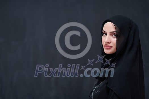 portrait of beautiful muslim woman in fashionable dress with hijab in front of black chalkboard representing modern islam fashion and ramadan kareem concept portrait of beautiful muslim woman in fashionable dress with hijab in front of black chalkboard representing modern islam fashion and ramadan kareem concept