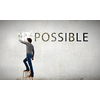 Man changing word impossible in to possible by erasing part of word with paint brush