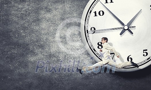 Concept of time with funny businessman running in a hurry Concept of time with funny businessman running in a hurry