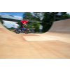 Bmx rider jumping over on a U ramp in a skatepark (motion blurred image)