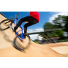 Bmx rider jumping over on a U ramp in a skatepark (motion blurred image)