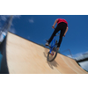 Bmx rider jumping over on a U ramp in a skatepark (motion blurred image)