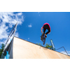 Bmx rider jumping over on a U ramp in a skatepark (motion blurred image)