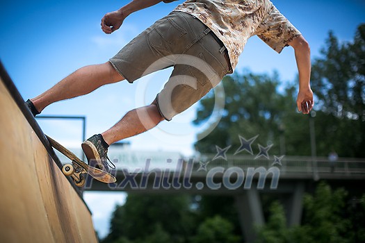 Skteboarder riding in an U ramp in a skatepark (motion blurred image) Skteboarder riding in an U ramp in a skatepark (motion blurred image)