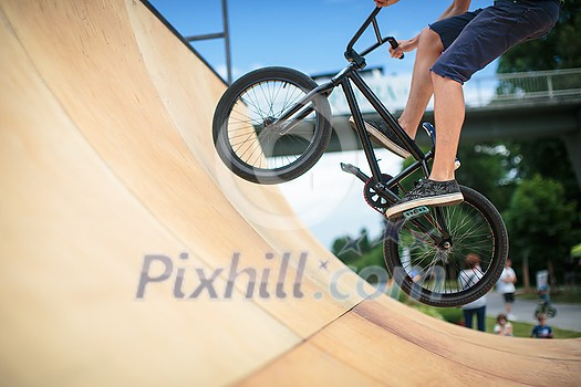 Bmx rider jumping over on a U ramp in a skatepark (motion blurred image) Bmx rider jumping over on a U ramp in a skatepark (motion blurred image)