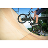 Bmx rider jumping over on a U ramp in a skatepark (motion blurred image)