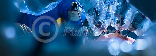 Surgery in a modern hospital being performed by a team of professionals (shallow DOF, color toned image) Surgery in a modern hospital being performed by a team of professionals (shallow DOF, color toned image)