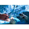 Surgery in a modern hospital being performed by a team of professionals (shallow DOF, color toned image)