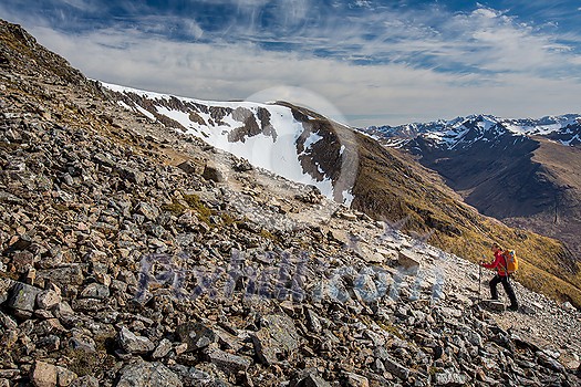 Pretty, young female hiker going uphill in beautiful highlands of Scotland Pretty, young female hiker going uphill in beautiful highlands of Scotland