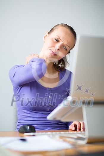 Working too hard - young woman working on a computer at an office, having sore back, being overloaded with work, sitting too much, putting too much stress on her eyes,.. Working too hard - young woman working on a computer at an office, having sore back, being overloaded with work, sitting too much, putting too much stress on her eyes,..