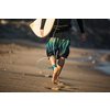 Young boy surfing the wave in a sunny day