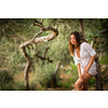 Attractive, young brunette on the beach, amid olive trees, looking both sensual and natural