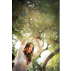 Attractive, young brunette on the beach, amid olive trees, looking both sensual and natural
