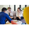 multiethnic group of business people playing chess while having a break in relaxation area at modern startup office
