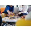 multiethnic group of business people playing chess while having a break in relaxation area at modern startup office