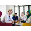 multiethnic group of business people playing chess while having a break in relaxation area at modern startup office