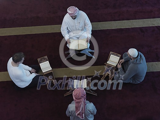 top view of muslim people in mosque reading quran together concept of islamic education and school of holly book kuran top view of muslim people in mosque reading quran together concept of islamic education and school of holly book kuran