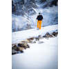 Winter sports - young man running with snowshoes downhill in high mountains covered with lots of snow