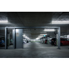 Gated underground parking. Cars parked in a garage with no people. Many cars in parking garage interior. Underground parking with cars (color toned image)