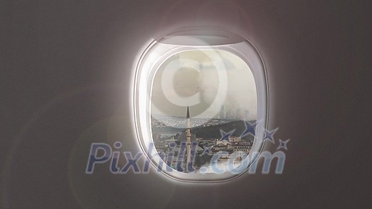 Panoramic aerial video of cityscape with buildings and houses of historical part of Istanbul, Turkey on a background of cloudy sky from porthole inside airplane.. 4K UHD video 3840, 2160p. Panoramic aerial video of cityscape with buildings and houses of historical part of Istanbul, Turkey on a background of cloudy sky from porthole inside airplane.. 4K UHD video 3840, 2160p.