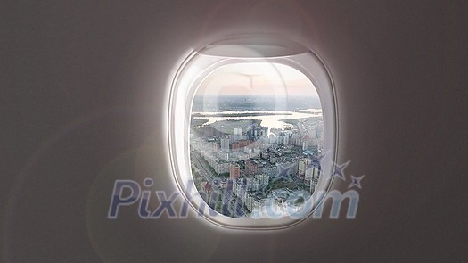 Panoramic aerial video of cityscape with modern buildings and houses of residential area of Kyiv, Ukraine on a background of cloudy sky from porthole inside airplane.. 4K UHD video 3840, 2160p. Panoramic aerial video of cityscape with modern buildings and houses of residential area of Kyiv, Ukraine on a background of cloudy sky from porthole inside airplane.. 4K UHD video 3840, 2160p.