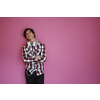 arab teenager with wearing  casual school look against pink background wearing headphones