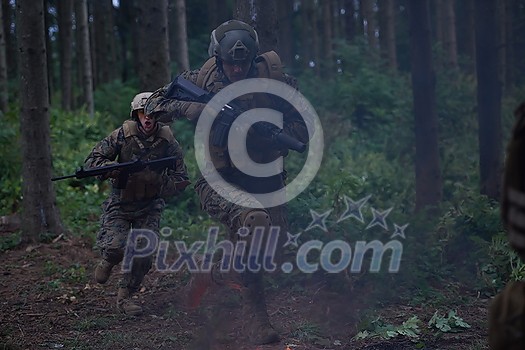Soldier in Action at Night in the Forest Area. Night Time Military Mission jumping over fire Soldier in Action at Night in the Forest Area. Night Time Military Mission jumping over fire
