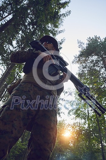 soldier portrait with protective army tactical gear and weapon having a break and relaxing soldier portrait with protective army tactical gear and weapon having a break and relaxing