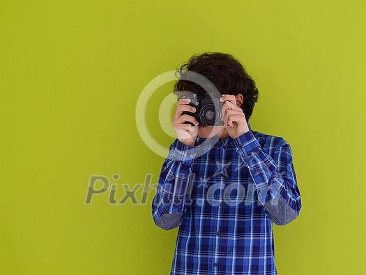 enthusuast arab teen photographer with analog slr camera on pink packground enthusuast arab teen photographer with analog slr camera on pink packground