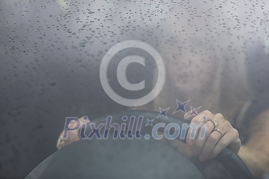 Pretty midle aged woman at the steering wheel of her car commuting to work Pretty midle aged woman at the steering wheel of her car commuting to work