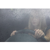 Pretty midle aged woman at the steering wheel of her car commuting to work
