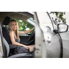 Pretty midle aged woman at the steering wheel of her car commuting to work