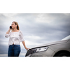 Pretty middle aged woman having car troubles - broken down car on the side of the road, calling the insurance company for assistance